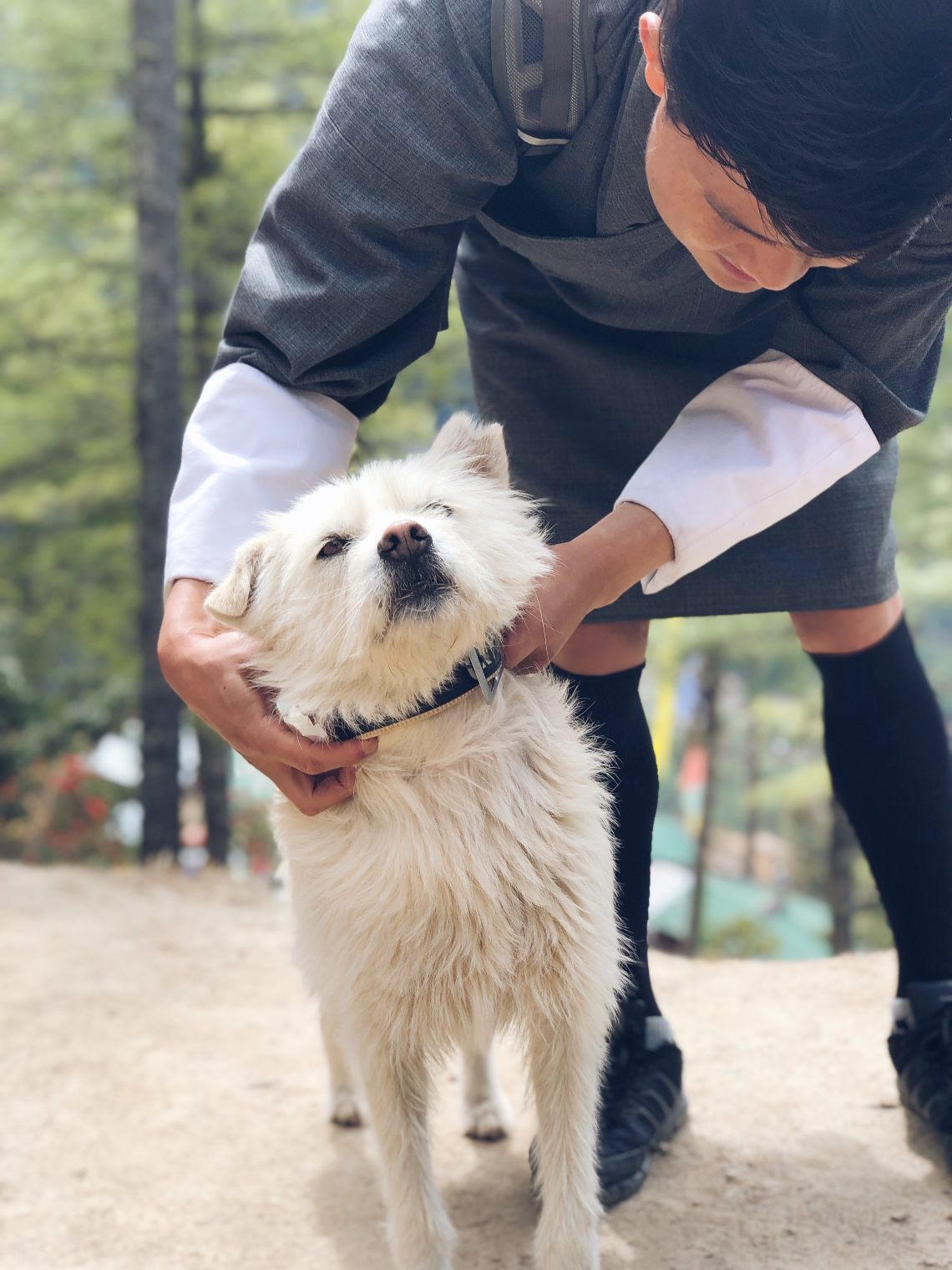 Dog with a man in traditional Bhutanese wear